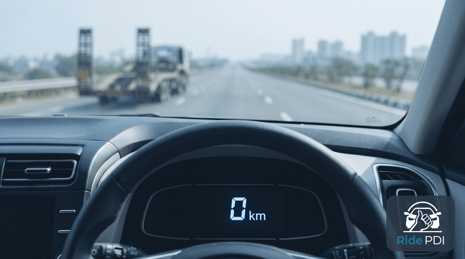 Close-up of a car odometer reading 0kms while being on a Highway.
